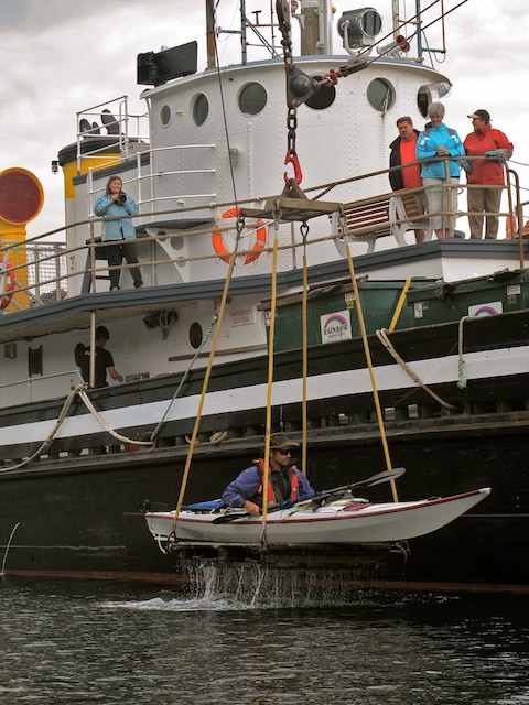 Kayaker being unloaded from the Uchuk III on Vancouver Island